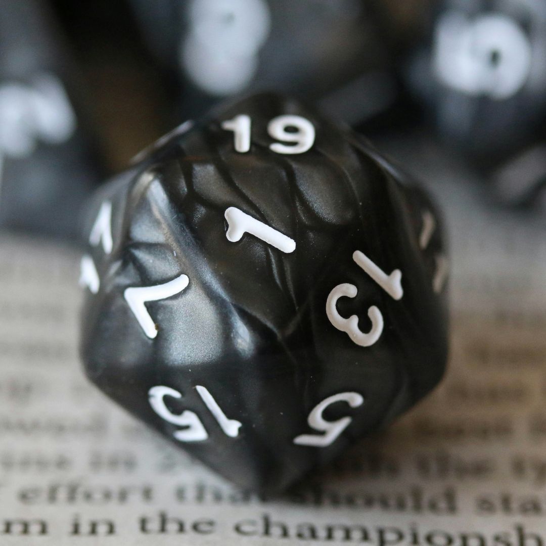 D20 resting on book page