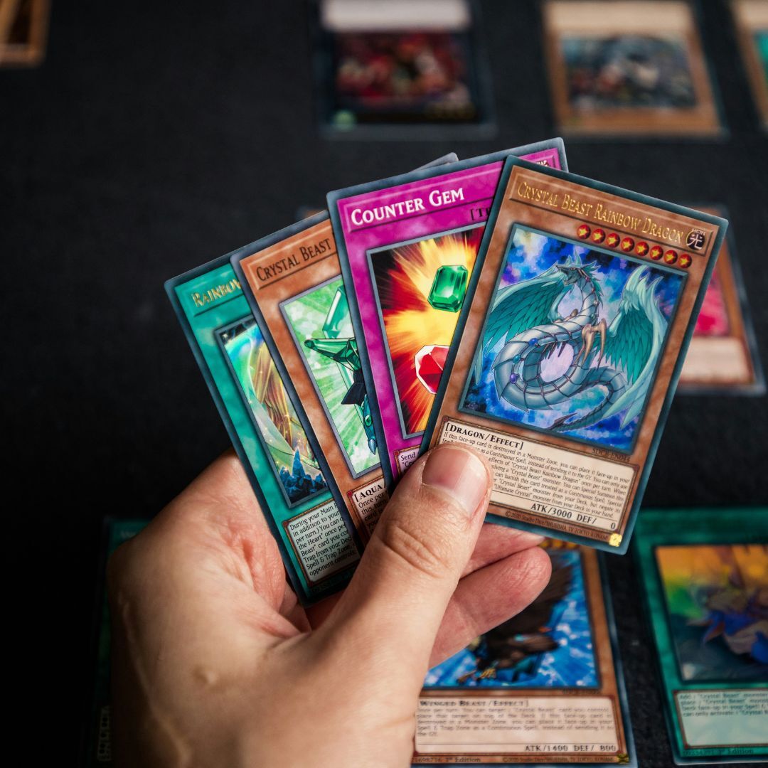 holding a hand of magic the gathering cards